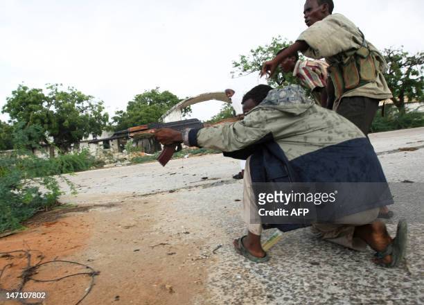 Al-Shabab militiamen fire on Somali government troops in the streets of Somalia's capital, Mogadishu on May 22, 2009. Fierce clashes today left at...
