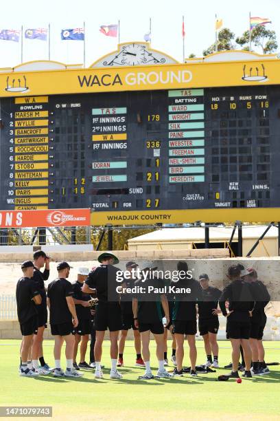 Tasmanian players and coaching staff huddle before commencing warm ups during the Sheffield Shield match between Western Australia and South...