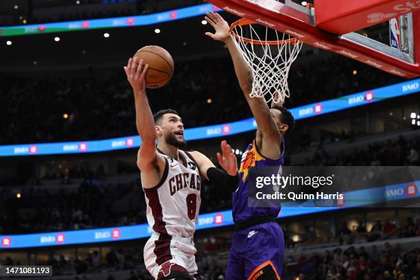 Zach LaVine of the Chicago Bulls goes to the basket and shoots in the first half against Cameron Payne of the Phoenix Suns at United Center on March...