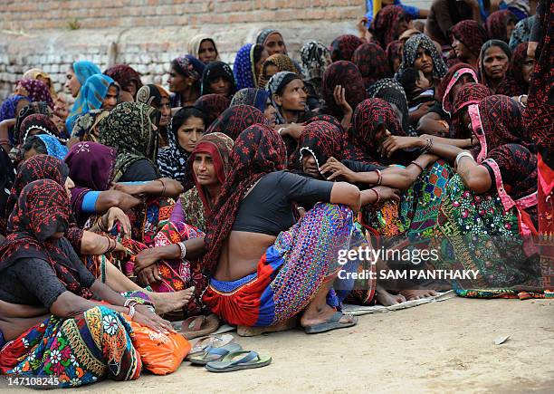 Relatives and community members gather at the home of Mahadev Bharwad during a Hindu ritual in the village of Kochariya of Bavla Taluka some 40 kms...