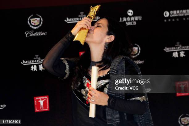 Mexican actress Ursula Pruneda poses with the trophy during the closing ceremony for the 15th Shanghai International Film Festival at Shanghai Grand...