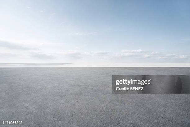 empty parking lot - bitumen stock pictures, royalty-free photos & images