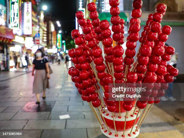 chinese hawthorn skewered candy 'bingtanghulu' model displayed on the street in yokohama chinatown - yokohama chinatown bildbanksfoton och bilder