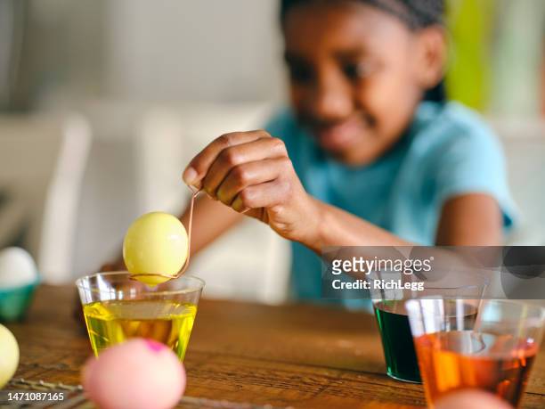 young girls decorating easter eggs - easter egg decorating stock pictures, royalty-free photos & images