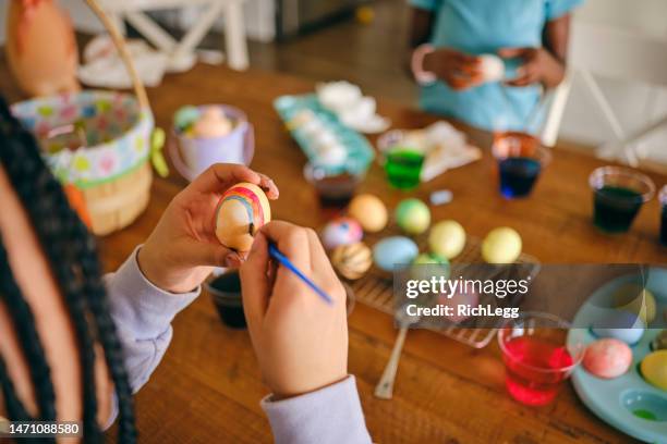 young girls decorating easter eggs - black dye stock pictures, royalty-free photos & images