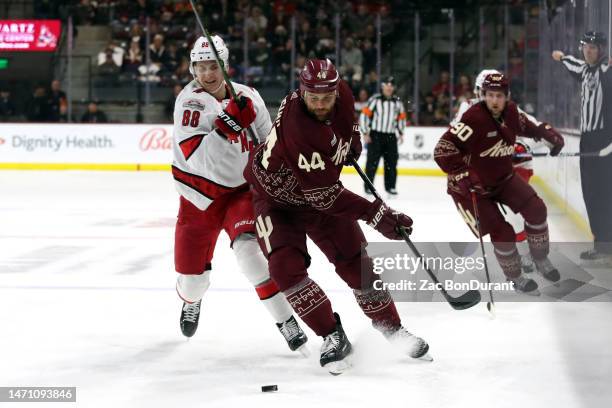Zack Kassian of the Arizona Coyotes makes a pass against Martin Necas of the Carolina Hurricanes in the first period at Mullett Arena on March 03,...