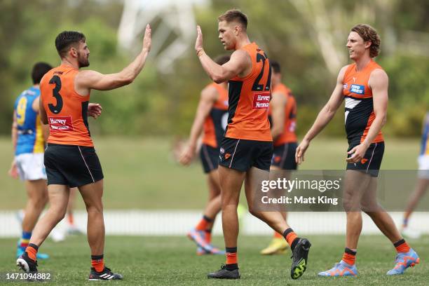 Harry Himmelberg of the Giants celebrates with team mates after kicking a goal during the AFL Practice Match between the Greater Western Sydney...