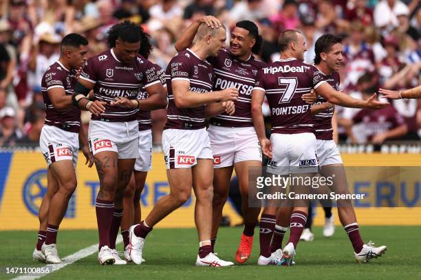 Tom Trbojevic of the Sea Eagles celebrates scoring a try with team mates during the round one NRL match between the Manly Sea Eagles and the...