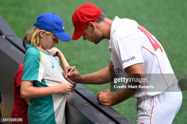Spencer Johnson of South Australia signs autographs for fans during the Sheffield Shield match between Queensland and South Australia at The Gabba,...