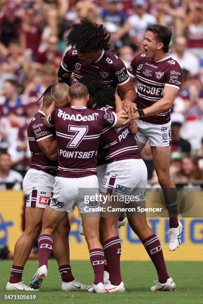 Tom Trbojevic of the Sea Eagles celebrates scoring a try with team mates during the round one NRL match between the Manly Sea Eagles and the...