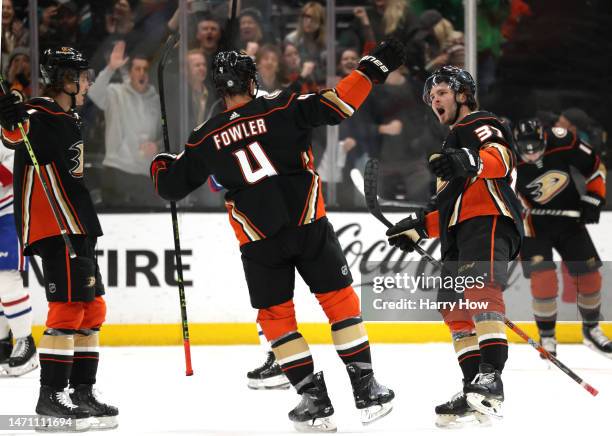 Mason McTavish of the Anaheim Ducks celebrates his power play goal with Cam Fowler and Trevor Zegras, to take a 2-1 lead, during a 3-2 Ducks win at...