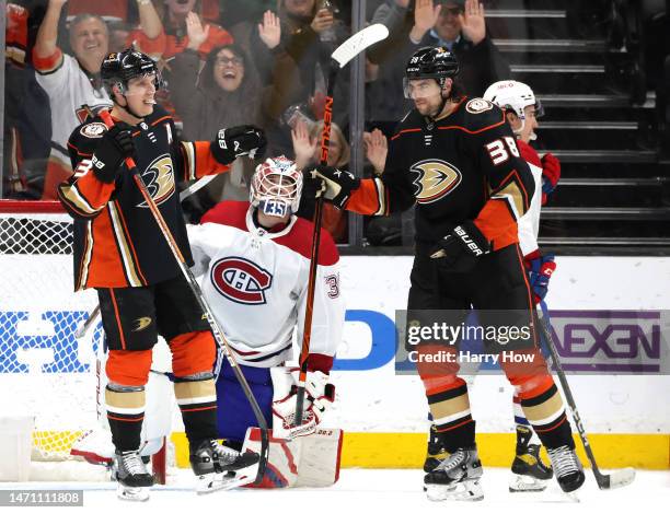 Jakob Silfverberg of the Anaheim Ducks celebrates his goal with Derek Grant in front of Sam Montembeault of the Montreal Canadiens, to take a 3-1...