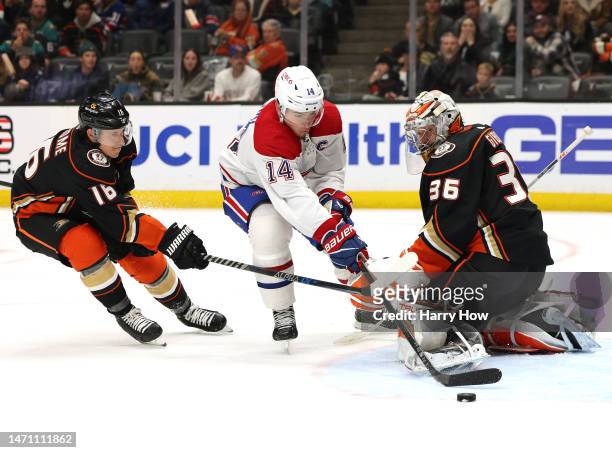 Nick Suzuki of the Montreal Canadiens misses a chance to score between John Gibson and Ryan Strome of the Anaheim Ducks during the third period in a...