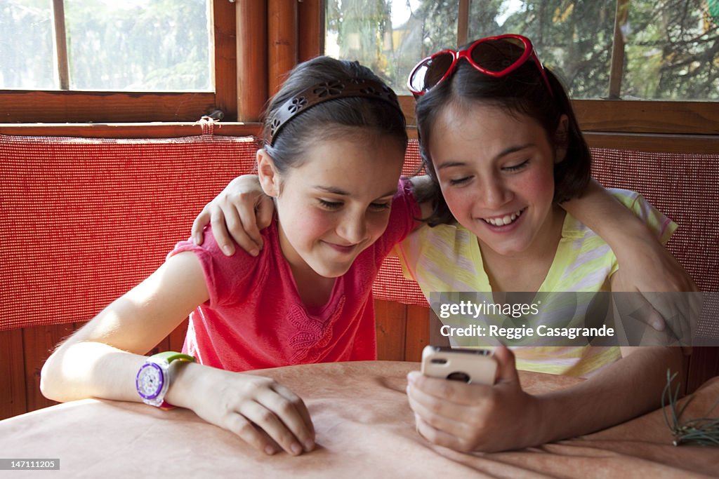 Two girls using a smart phone