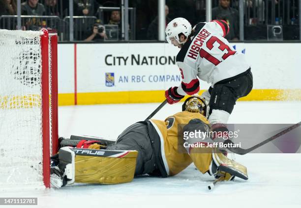 Adin Hill of the Vegas Golden Knights makes a save against Nico Hischier of the New Jersey Devils during overtime at T-Mobile Arena on March 03, 2023...