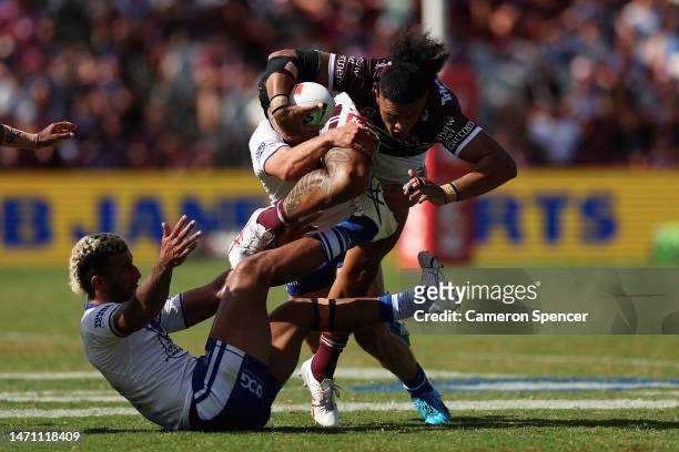 Haumole Olakau'atu of the Sea Eagles is tackled during the round one NRL match between the Manly Sea Eagles and the Canterbury Bulldogs at 4 Pines...