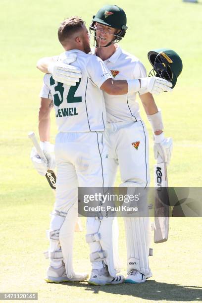 Caleb Jewell of Tasmania celebrates his century with Jordan Silk during the Sheffield Shield match between Western Australia and South Australia at...