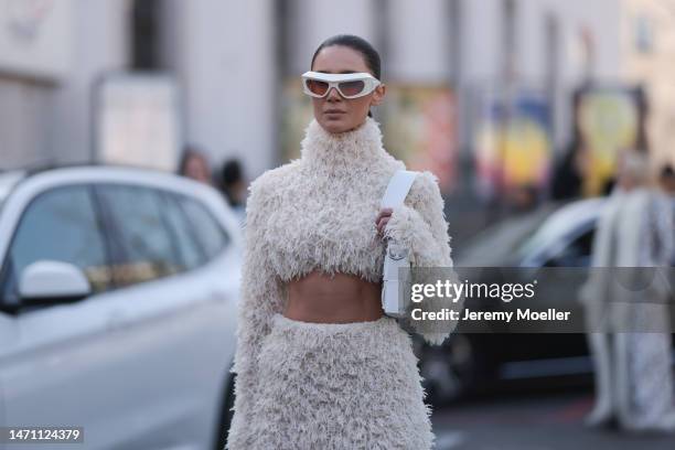 Sabina Jakubowicz seen wearing a white fluffy Dawid Wolinski dress, white Coperni sunnies and Versace heels before the Giambattista Valli show on...