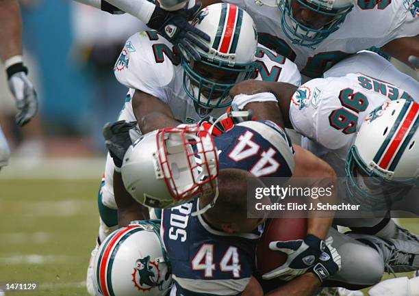 Marc Edwards of the New England Patriots looses his helmet after a hit by the Miami Dolphins defense in the first half on October 6, 2002 at Pro...