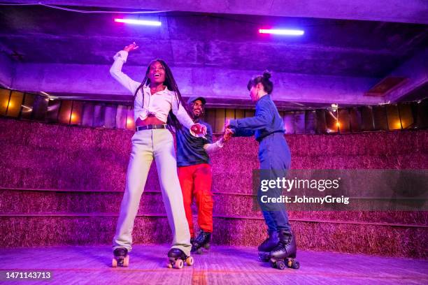 three young friends roller skate dancing - roller disco stock pictures, royalty-free photos & images
