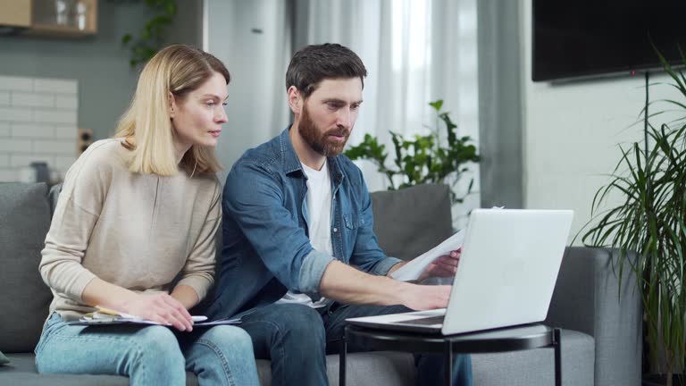 https://media.gettyimages.com/id/1471144778/video/accounting-at-home-happy-couple-using-laptop-computer-sitting-on-sofa-in-house-family-filling.jpg?b=1&s=640x640&k=20&c=XMGW7k2CpgmDulzUfo4kIPEiD3g0sHPJsF2NhP64xZE=