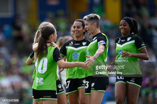 Michelle Heyman and Grace Maher of Canberra United of Canberra United celebrate with their team after Michelle Heyman kicks a goal during the round...