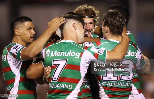 Campbell Graham of the Rabbitohs celebrates with his team mates after scoring a try during the round one NRL match between Cronulla Sharks and South...