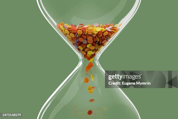 digitally generated image of colored dollar coins hourglass. time is money - tempo concetto foto e immagini stock