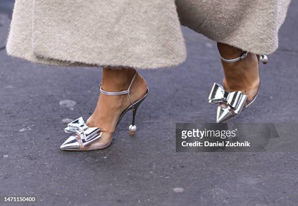 Guest is seen wearing a silver bow Giambattista Valli heels outside the Giambattista Valli show during Paris Fashion Week F/W 2023 on March 03, 2023...