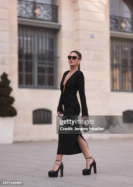 Füsun Lindner seen wearing Celine black sunglasses, Maison Ju black v-neck long dress with long sleeves, Ole Lynggaard gold elephant pendant necklace...