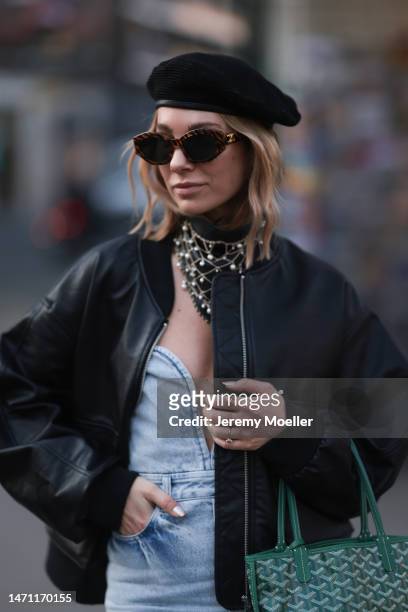 Karin Teigl seen wearing Celine brown sunglasses, Gucci black beret hat, H&M Studio light blue sleeveless denim / jeans long dress, Edited black...
