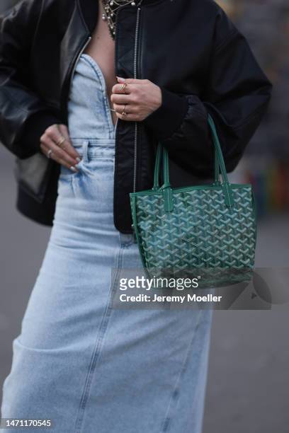 Karin Teigl seen wearing H&M Studio light blue sleeveless denim long dress, Edited black leather jacket, Chanel black bandana with chains and pearls,...
