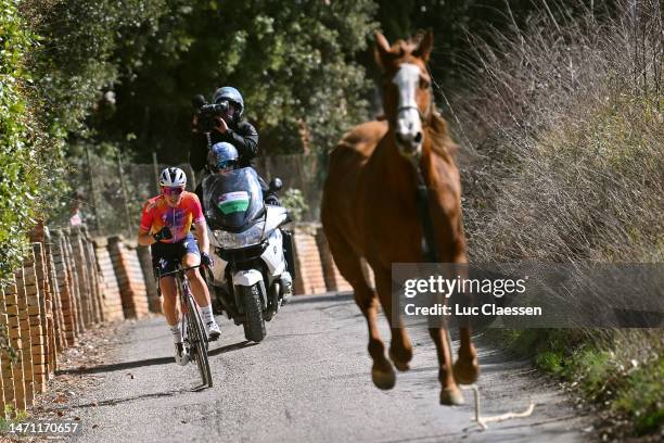 Demi Vollering of The Netherlands and Team SD Worx attacks while a horse gallops beside her during the Eroica - 9th Strade Bianche 2023, Women's a...