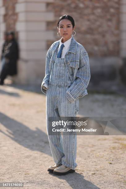 Yoyo Cao seen wearing a blue and white striped jeans jacket, matching blue and white striped dungarees, a blue necktie, beige patent loafers and a...