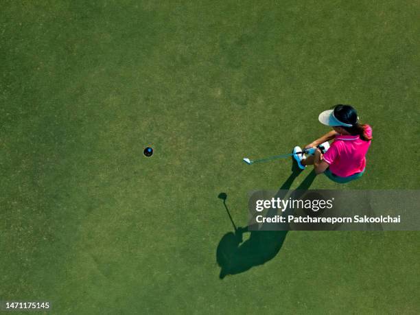 on green golf - professional golfer stock pictures, royalty-free photos & images