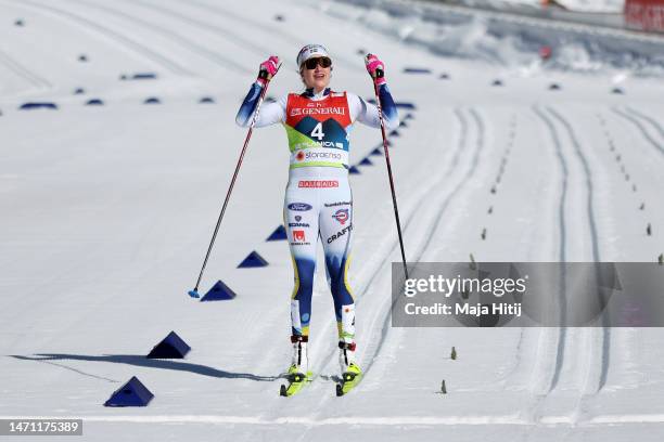 Gold medalist Ebba Andersson of Sweden celebrates victory as she crosses the finish line to win the Cross-Country Women's 30km Mass Start Classic at...