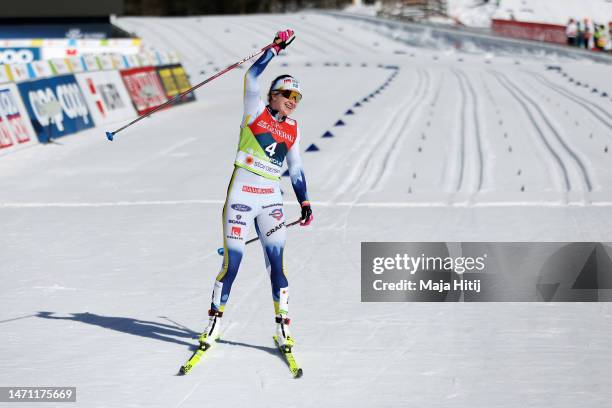 Gold medalist Ebba Andersson of Sweden celebrates victory as she crosses the finish line to win the Cross-Country Women's 30km Mass Start Classic at...