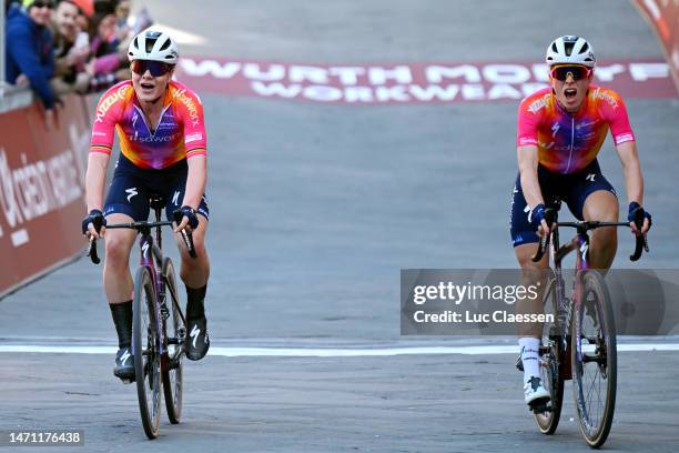 Lotte Kopecky of Belgium on second place and the race winner Demi Vollering of The Netherlands and Team SD Worx cross the finish line during the...