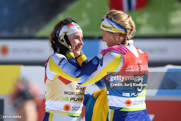 Gold medalist Ebba Andersson of Sweden and bronze medalist Frida Karlsson of Sweden celebrate after the Cross-Country Women's 30km Mass Start Classic...