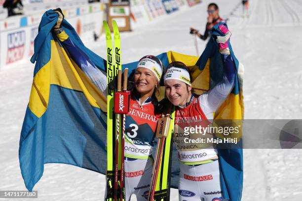 Gold medalist Ebba Andersson of Sweden and bronze medalist Frida Karlsson of Sweden celebrate after the Cross-Country Women's 30km Mass Start Classic...