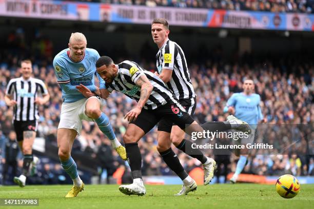 Erling Haaland of Manchester City and Jamaal Lascelles of Newcastle United clash during the Premier League match between Manchester City and...