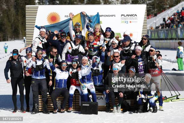 Gold medalist Ebba Andersson of Sweden and bronze medalist Frida Karlsson of Sweden celebrates with team members during the victory ceremony for...