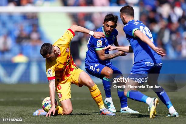 Angel Algobia of Getafe CF is challenged players of Girona FC during the LaLiga Santander match between Getafe CF and Girona FC at Coliseum Alfonso...