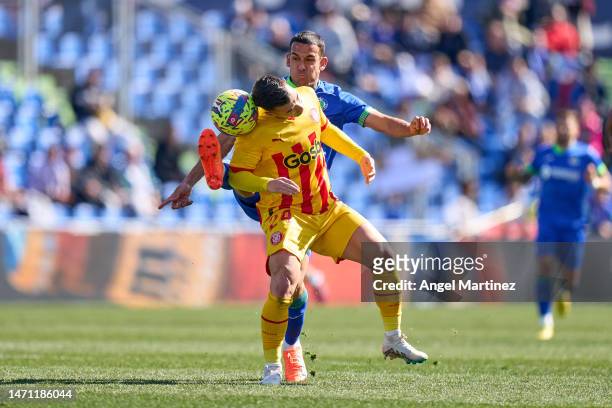 Borja Garcia of Girona FC competes for the ball with Angel Algobia of Getafe CF during the LaLiga Santander match between Getafe CF and Girona FC at...