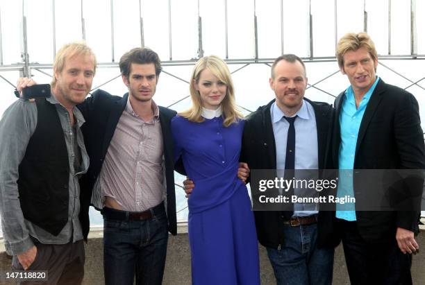 Actor Rhys Ifans, actor Andrew Garfield, actor Emma Stone, director Marc Webb, and actor Denis Leary lights The Empire State Building on June 25,...