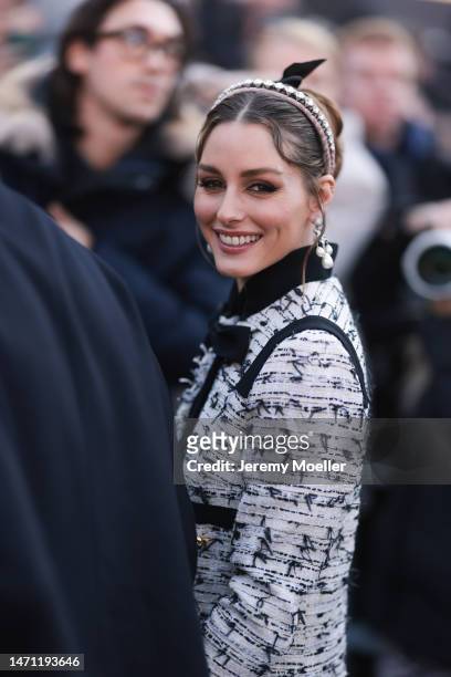 Olivia Palermo seen wearing a sparkling hairband, pearl earrings and a black and white patterned blazer before the Giambattista Valli show on March...