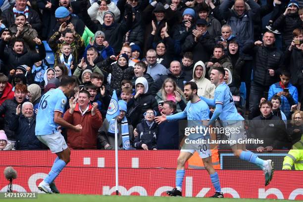 Bernardo Silva of Manchester City celebrates with teammates after scoring the team's second goal during the Premier League match between Manchester...