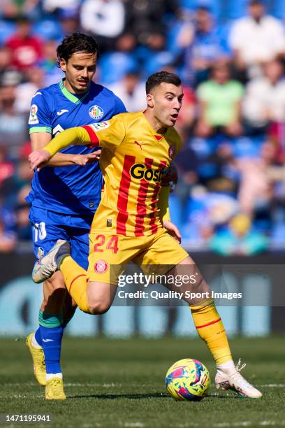 Enes Unal of Getafe CF battle for the ball with Borja Garcia of Girona FC during the LaLiga Santander match between Getafe CF and Girona FC at...