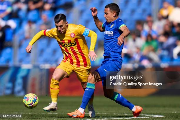 Enes Unal of Getafe CF battle for the ball with Borja Garcia of Girona FC during the LaLiga Santander match between Getafe CF and Girona FC at...