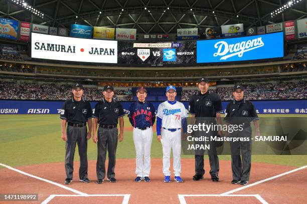 Head coach Hideki Kuriyama of Samurai Japan and Head coach Kazuyoshi Tatsunami of Chunichi Dragons pose with umpires prior to the practice game...